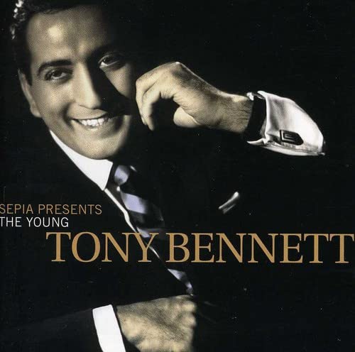 Sepia-toned portrait of a smiling young Tony Bennett in a suit.