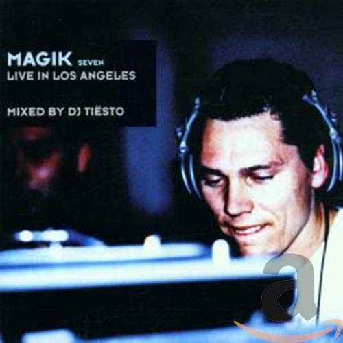 DJ Tiesto wearing headphones behind a mixing console on a dark album cover.