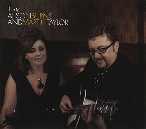 Album cover featuring a man playing guitar beside a smiling woman, both in black attire.