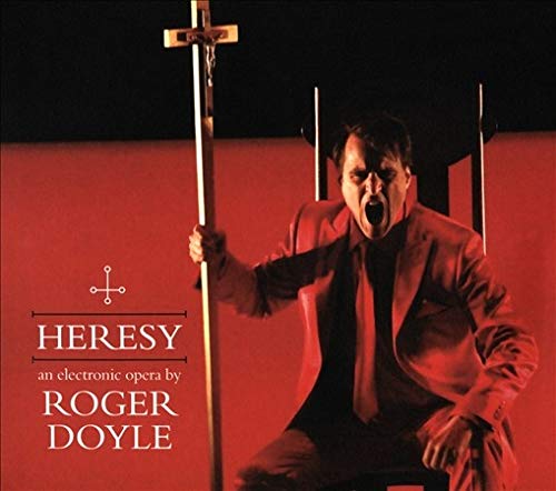 Man in red suit holding cross, screaming, on red-lit album cover for "Heresy".