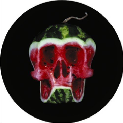 A watermelon carved into a skull on a black vinyl record sleeve.