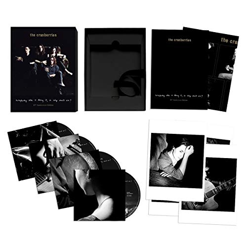 "CD case and contents with black and white photos and CDs on a white background."