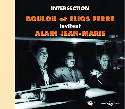 CD cover featuring three smiling men and a guitar in a dimly lit room.