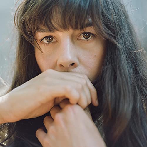 Close-up portrait of Madi Diaz, a person with brown hair and eyes.