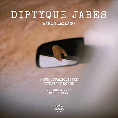 CD cover: hand reaching into a car side mirror, sandy background.
