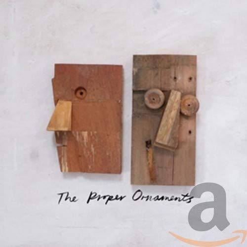 CD cover with abstract wooden sculpture and band name text.