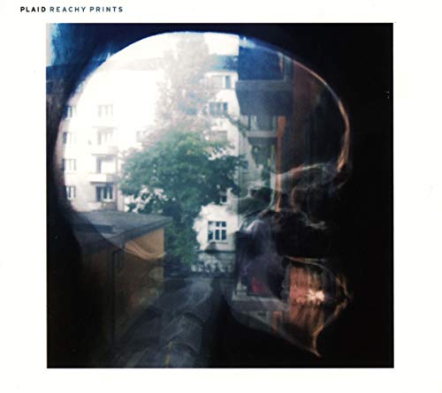 Double exposure of a human skull silhouette overlaid on an urban apartment building scene.