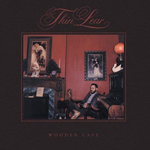 Album cover for Thin Lear’s “Wooden Cave” featuring a man in a room.