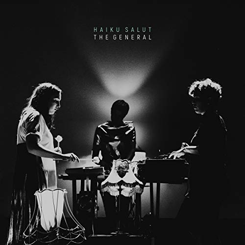 Black and white album cover featuring three figures with instruments.