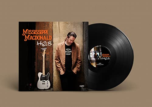 Vinyl record and album cover featuring a musician with a guitar.
