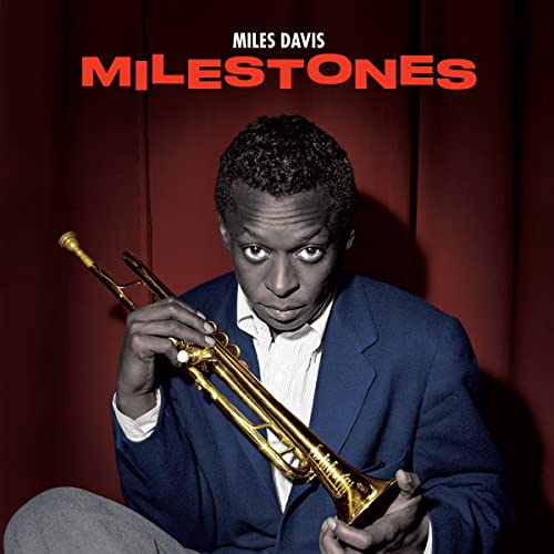 Miles Davis holding a trumpet, album cover for “Milestones.”