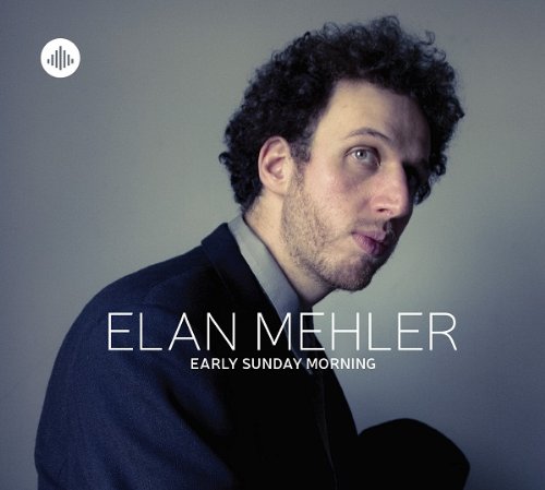 "Album cover featuring a man in a suit against a gray background."