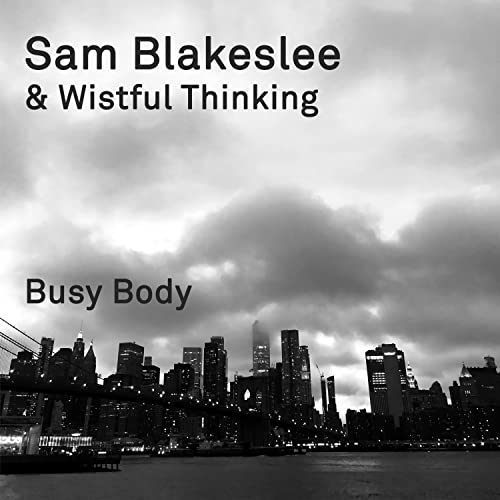 CD cover for Sam Blakeslee & Wistful Thinking’s “Busy Body” with a city skyline.