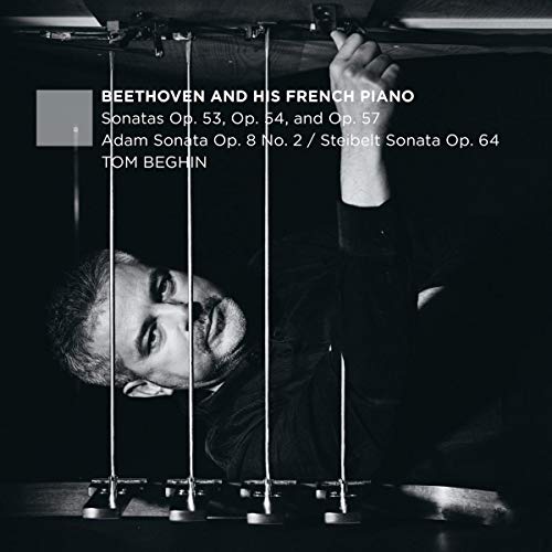 Black and white image of a man playing piano, with text overlay describing the album.