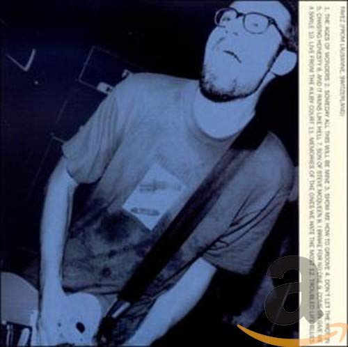 CD cover featuring a grainy, close-up portrait of a man with glasses.