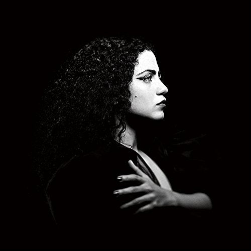 Black and white portrait of a woman with long, curly hair.