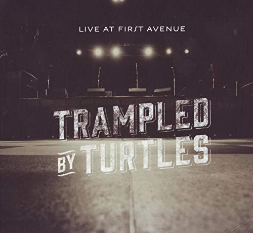 "CD cover with 'Trampled by Turtles' text on a dark stage background."
