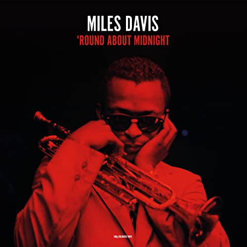 Miles Davis portrait in red tones, holding a trumpet to his lips.