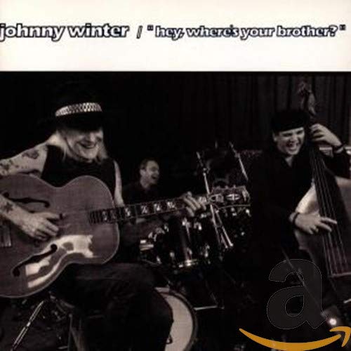 Black and white photo of Johnny Winter playing guitar with another musician.