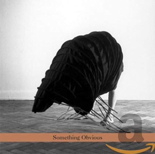 CD cover: a figure draped in black fabric with spiky legs.
