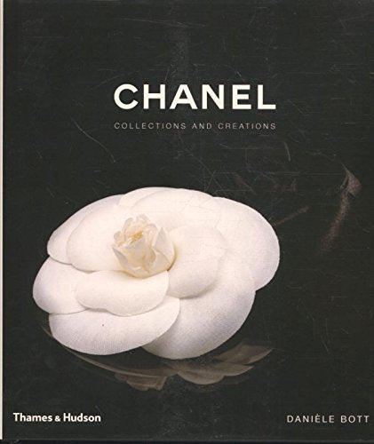 Book cover with a white camellia flower on a black reflective surface, titled "Chanel".