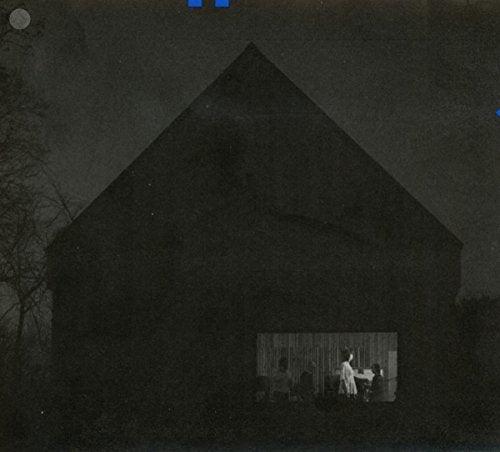 "CD case cover featuring a dark barn with a window showing people inside."