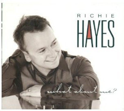 "CD cover with a man leaning on a table, smiling, and artist's name."