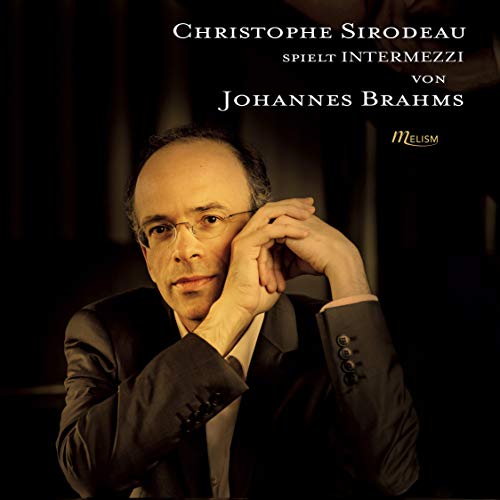 A man in a suit is on a CD cover with white and gold text.