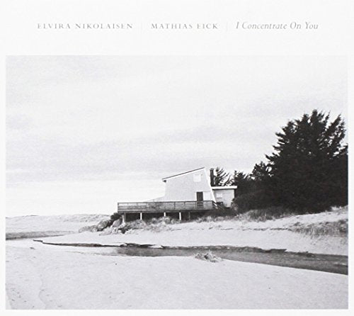 "Album cover featuring a black and white image of a house on a beach."