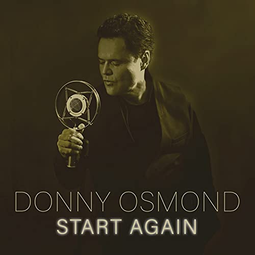 Donny Osmond portrait with vintage microphone, album title "Start Again" below.