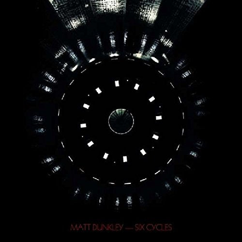 The image is a dark, abstract album cover for "Six Cycles" by Matt Dunkley. Here is a concise description of the image in 15 words or less: Dark, circular design with a central void, surrounded by scattered, glowing rectangles.