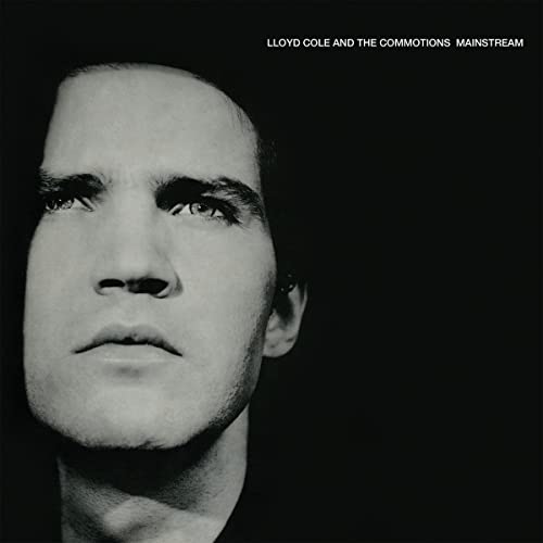 Black and white vinyl record cover featuring a close-up of a man’s face.