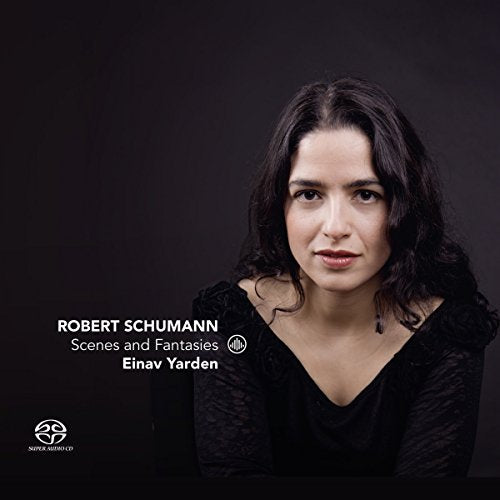 A woman with dark hair and a black top on a dark background, album cover.