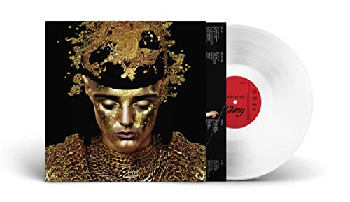 Vinyl record and album cover featuring a gold-adorned person’s face.