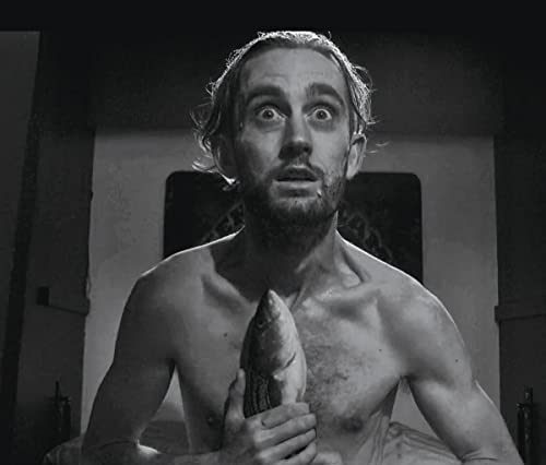 Black and white portrait of a startled man holding a fish.