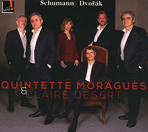 "CD cover featuring five musicians, one seated, in formal attire against a dark background."