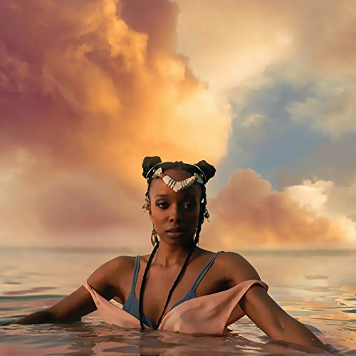 Jamila Woods portrait, waist-deep in water, wearing a silver headpiece.