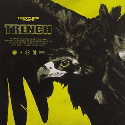 The image is an album cover for the band twenty one pilots, titled "Trench". To create a concise, descriptive alt text, we can analyze the key visual characteristics and the main subject of the image. The dominant feature is a black bird with a yellow eye, set against a yellow background. The bird's head is turned to the left, showcasing its sharp beak and detailed feathers. The title "Trench" is prominently displayed in bold, yellow font at the top-left corner
