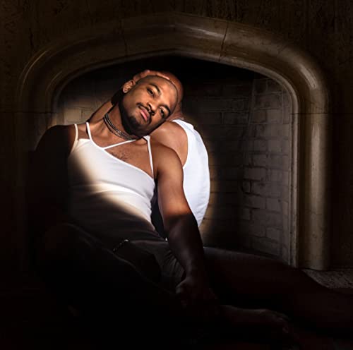 CD cover featuring a shirtless man reclining in an arched doorway.