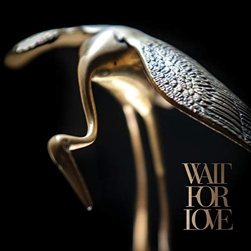 Golden bird sculptures against a black background with album title text.