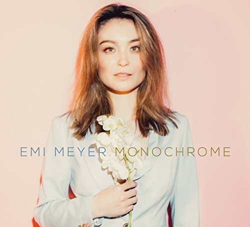 "Album cover featuring a woman holding a white flower against a pink background."