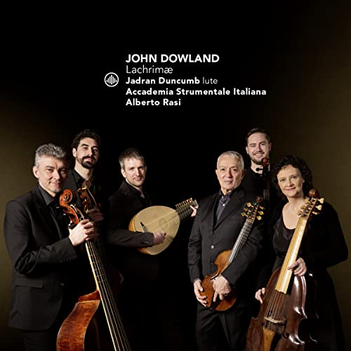Six musicians with stringed instruments, dark suits, and a black background.