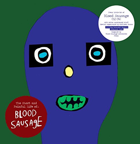 Blue cartoon face with large eyes and an open-mouthed grin, vinyl record.