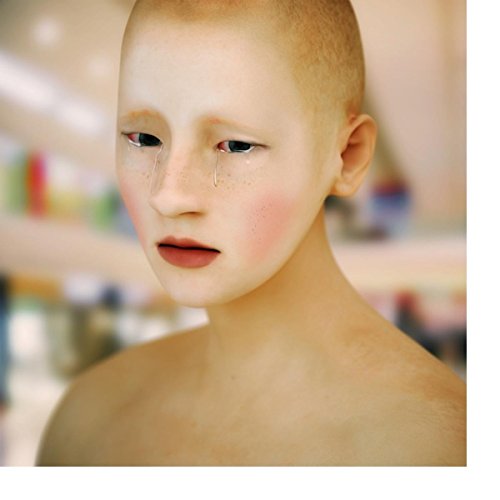 Close-up portrait of a young person with pale skin and red blush.