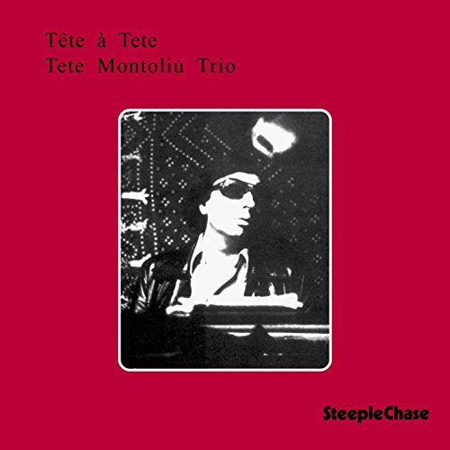 Red album cover featuring a black and white photo of a pianist.