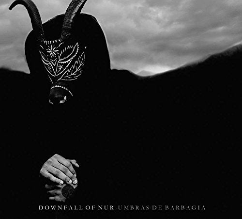 Dark figure with horns and patterned face against a cloudy sky.