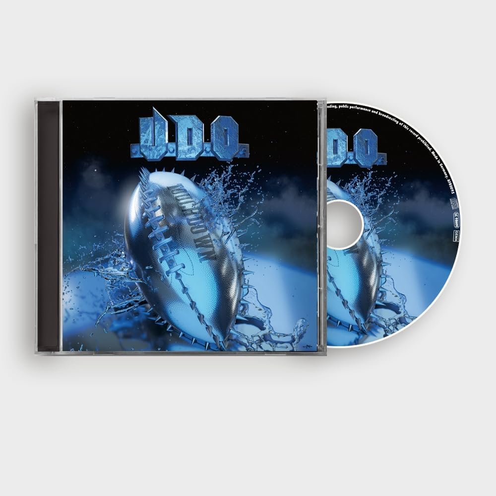 "CD case and disc with blue football artwork and 'U.D.O.' text on a black background."