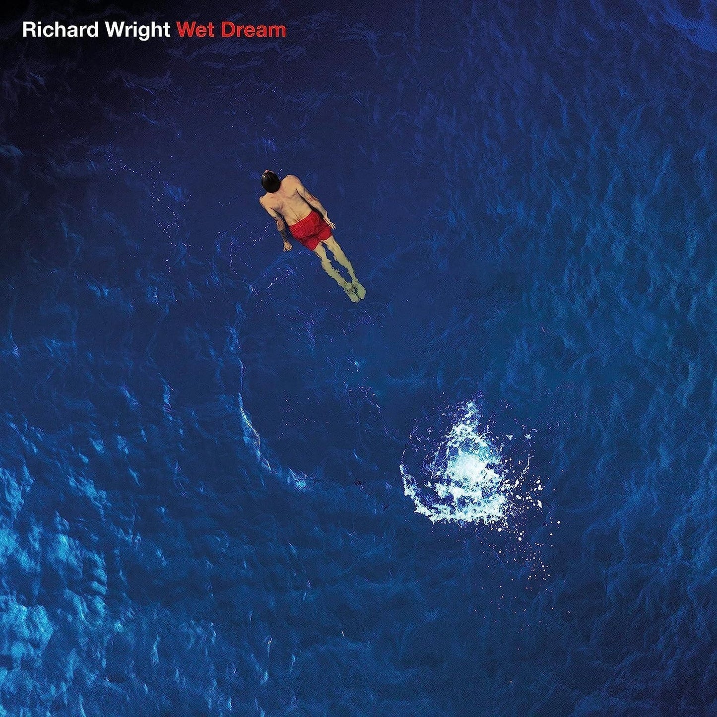 "Album cover with man in red swim trunks floating in blue water."