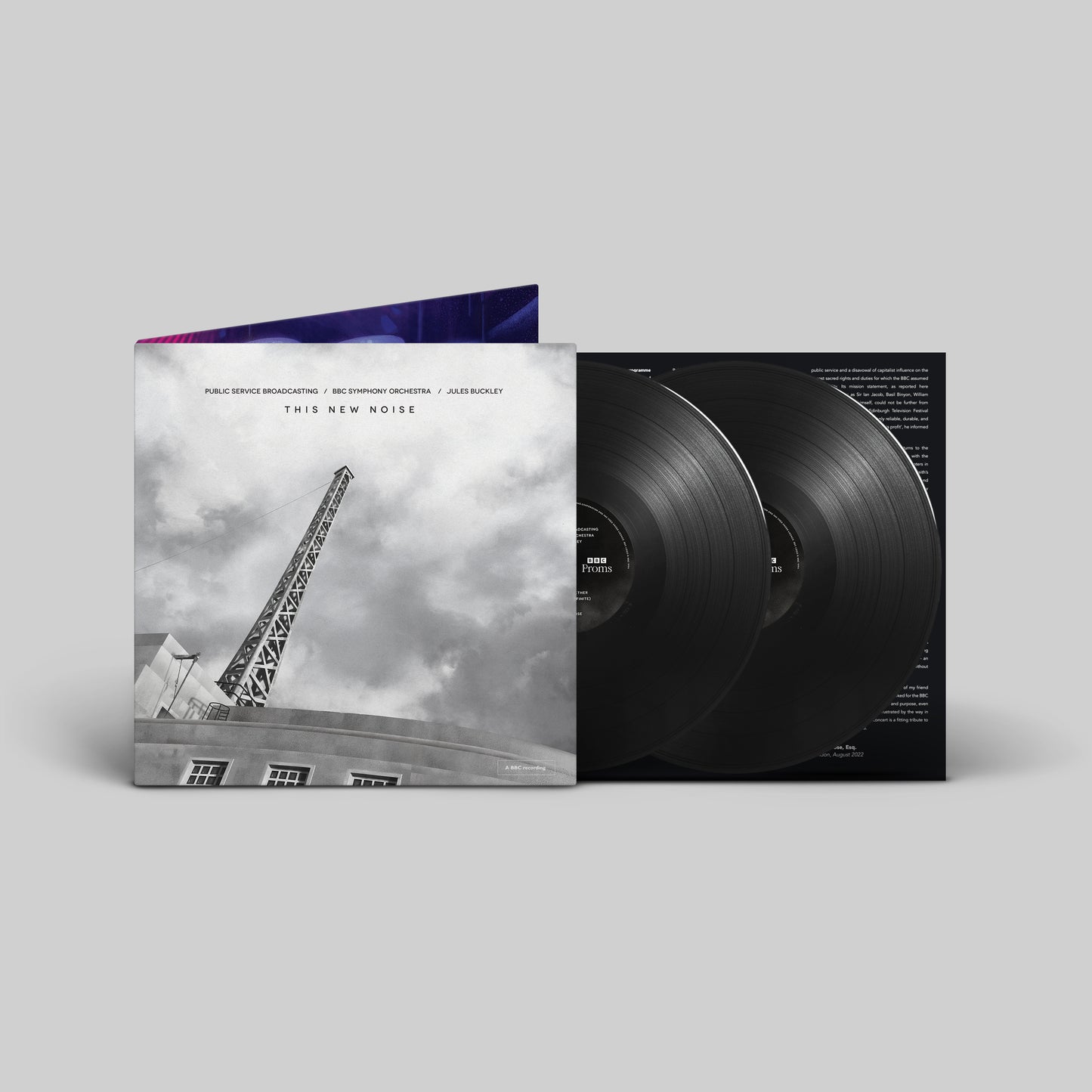 Vinyl record album cover with black and white image and two vinyl records inside.