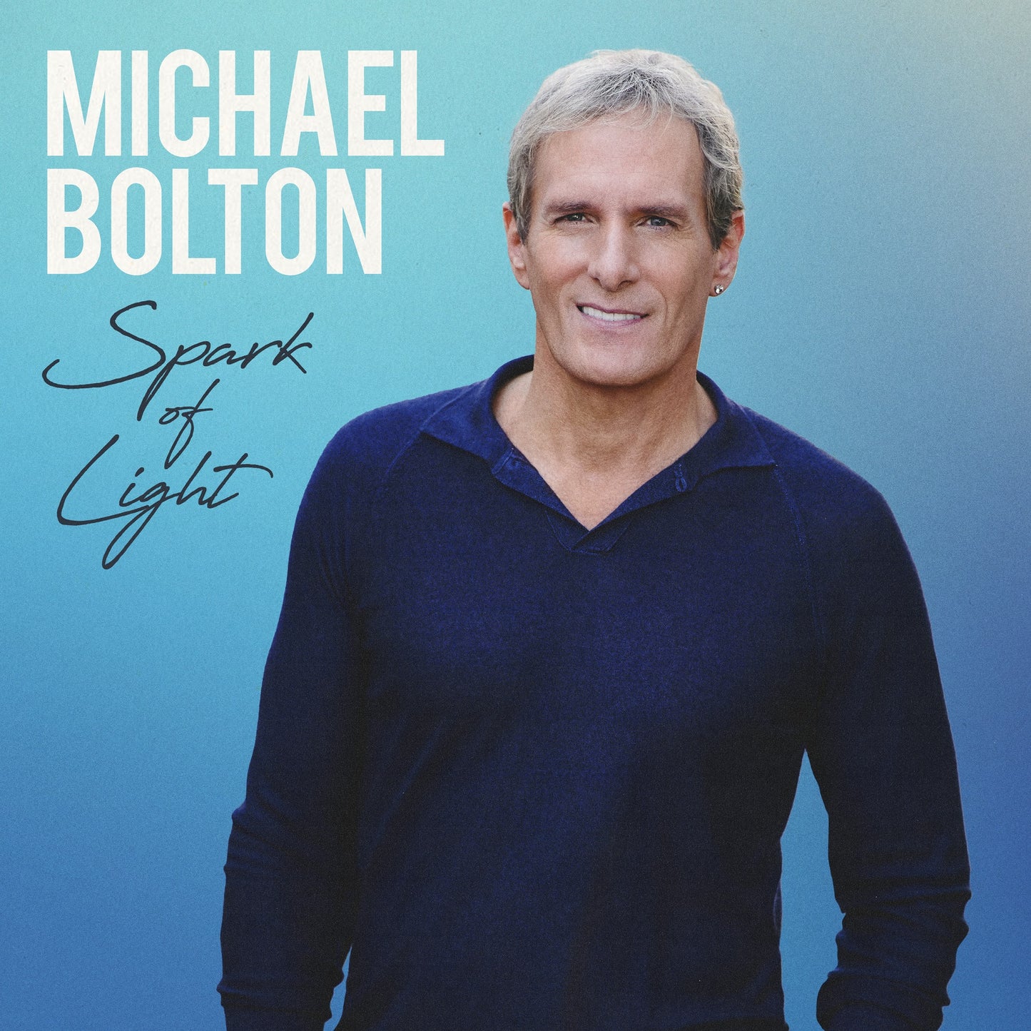 "Album cover featuring Michael Bolton against a blue background with 'Spark of Light' text."